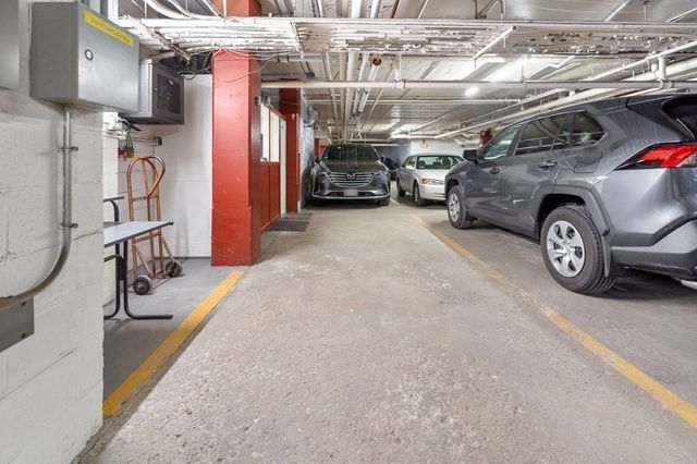 a view of parking garage with cars parked