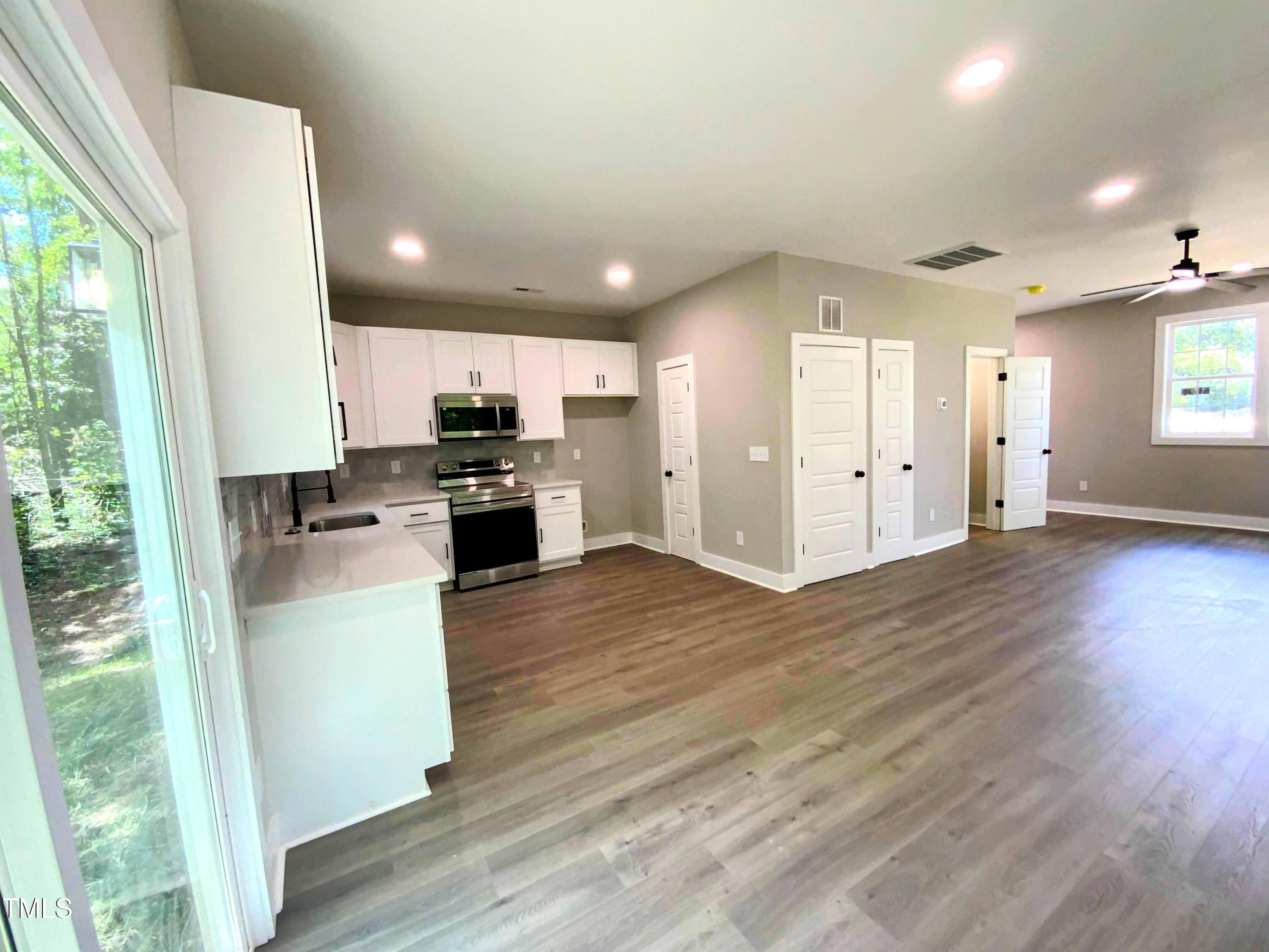 608 East Umstead Street Durham, NC 27701 - Photo 5 of 20 a kitchen with granite countertop a stove top oven a sink and a refrigerator