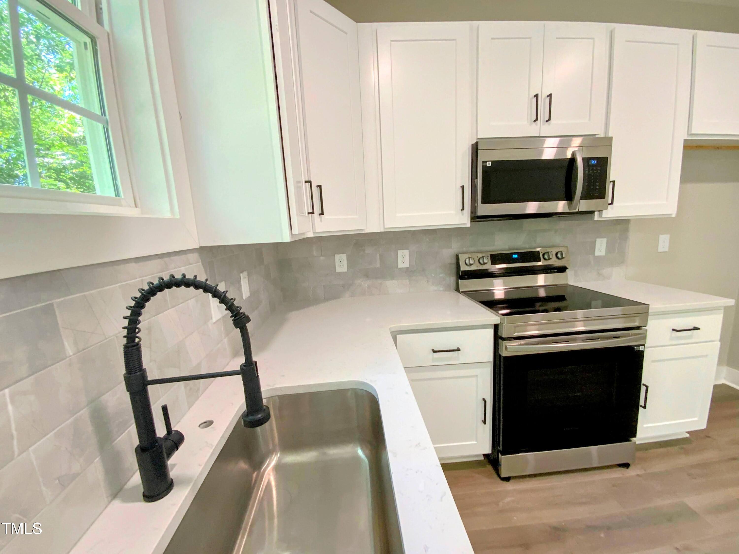608 East Umstead Street Durham, NC 27701 - Photo 7 of 20 a kitchen with a microwave and a stove