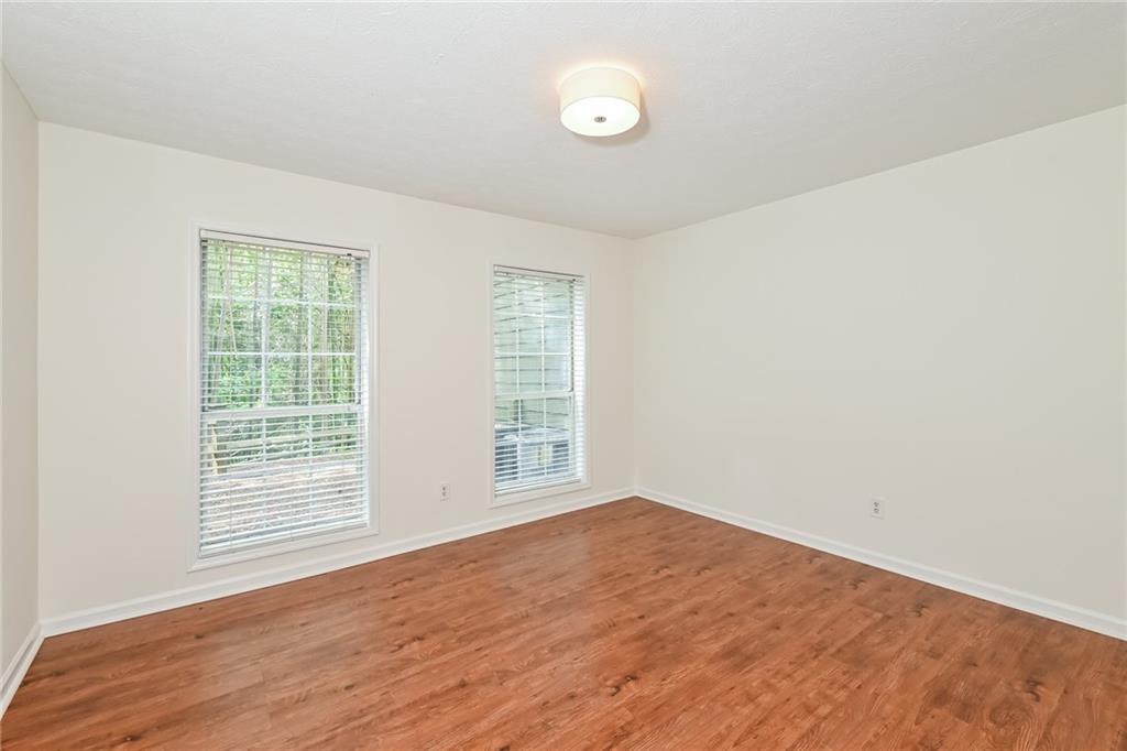 201 Lenox Way Northeast Atlanta, GA 30324 - Photo 11 of 15 an empty room with wooden floor and windows