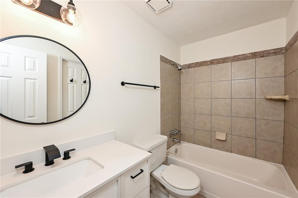 201 Lenox Way Northeast Atlanta, GA 30324 - Photo 13 of 15 a bathroom with a sink a toilet and a mirror