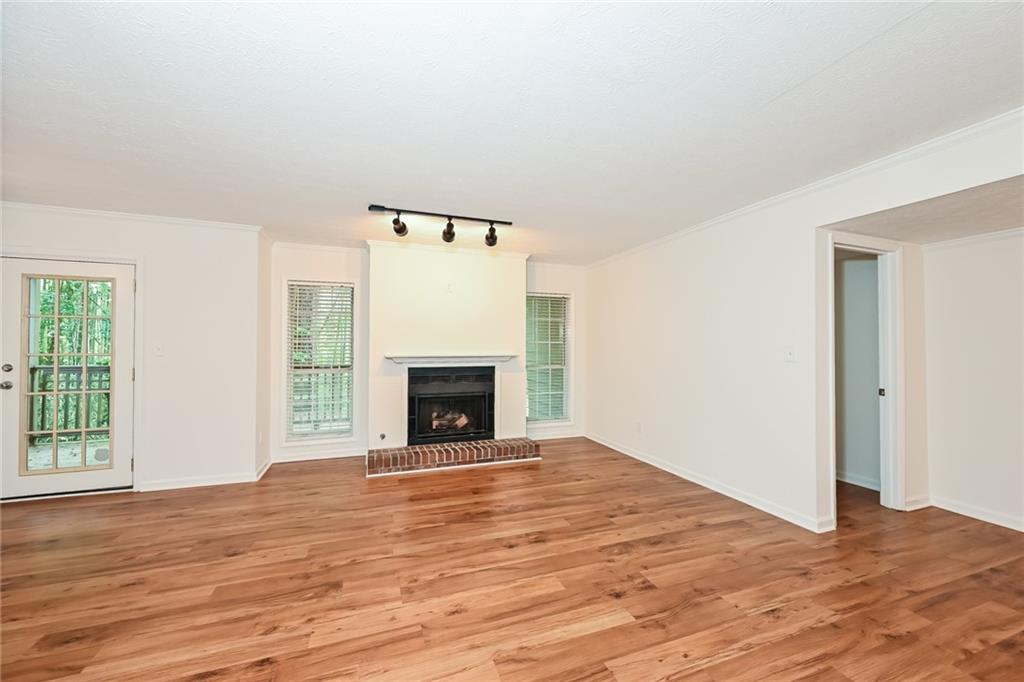 201 Lenox Way Northeast Atlanta, GA 30324 - Photo 2 of 15 a view of empty room with wooden floor and fireplace