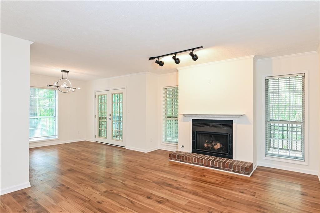 201 Lenox Way Northeast Atlanta, GA 30324 - Photo 3 of 15 a view of empty room with wooden floor and fireplace