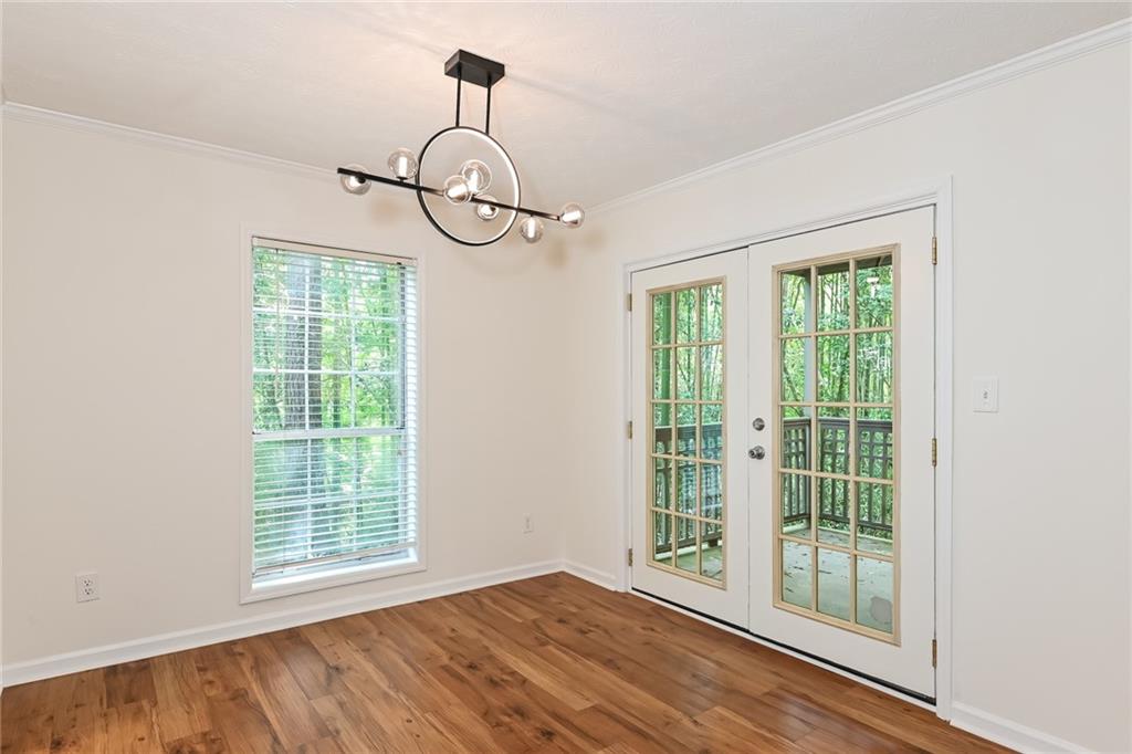 201 Lenox Way Northeast Atlanta, GA 30324 - Photo 4 of 15 a view of empty room with windows and wooden floor
