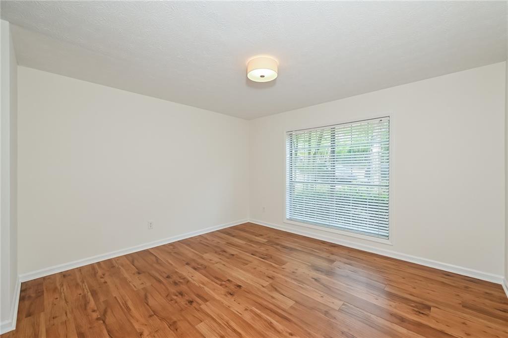 201 Lenox Way Northeast Atlanta, GA 30324 - Photo 9 of 15 an empty room with wooden floor and windows