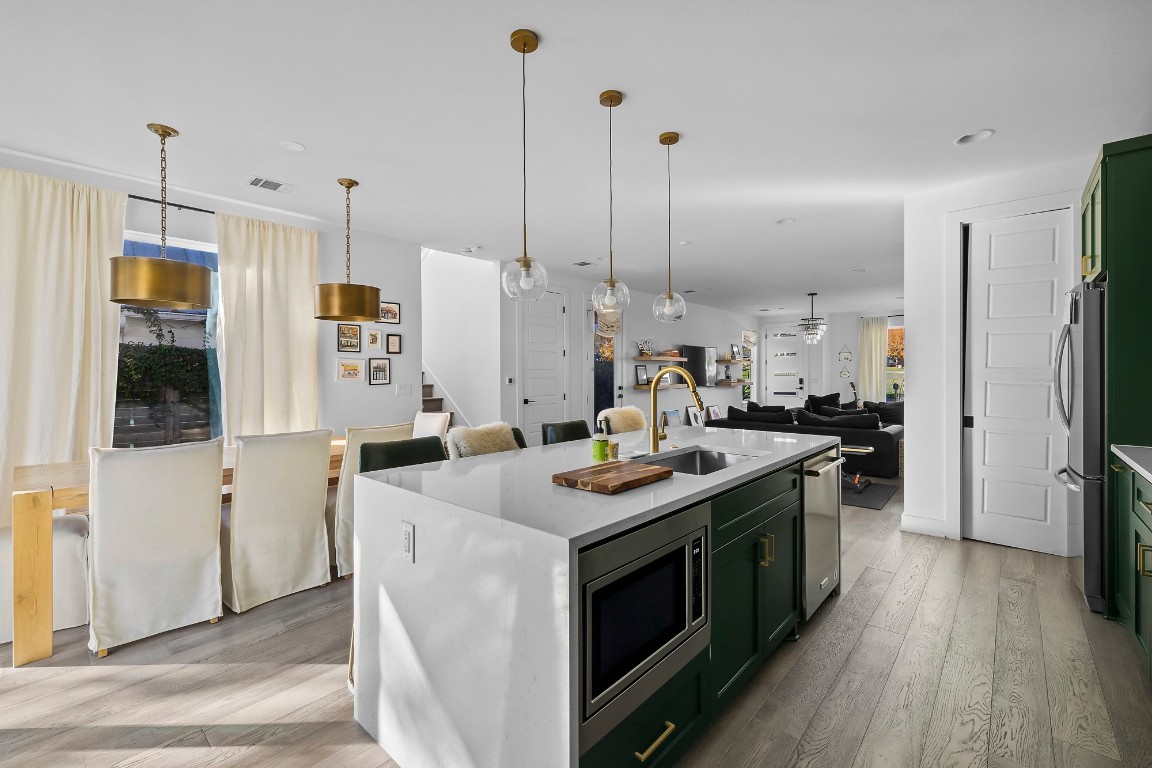 404 Powell Circle, Unit B Austin, TX 78704 - Photo 12 of 33 a kitchen with a sink stove and refrigerator