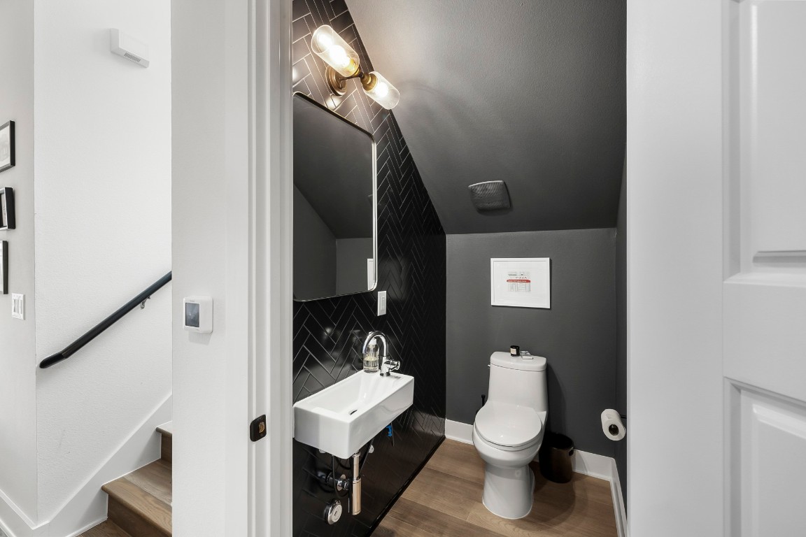 404 Powell Circle, Unit B Austin, TX 78704 - Photo 15 of 33 a bathroom with a toilet a sink and mirror