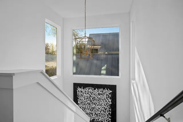 a picture of a room with a floor to ceiling window and a kitchen view