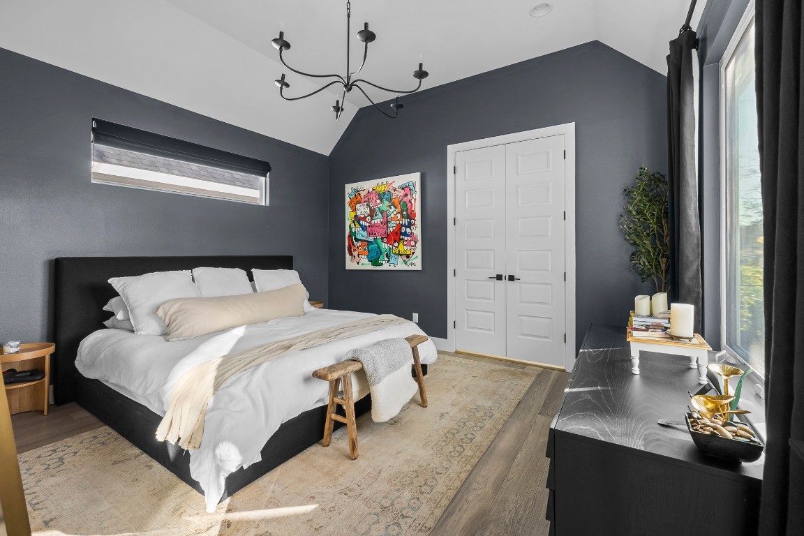 404 Powell Circle, Unit B Austin, TX 78704 - Photo 18 of 33 a bedroom with a large bed and a chandelier