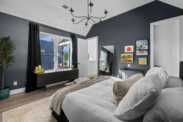 a bathroom with double vanity sinks a vanity a lamp and a mirror