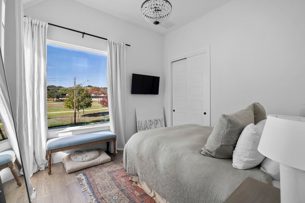 404 Powell Circle, Unit B Austin, TX 78704 - Photo 26 of 33 a bedroom with a bed and a window