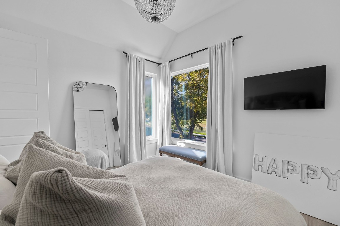 404 Powell Circle, Unit B Austin, TX 78704 - Photo 27 of 33 a bedroom with a bed and a flat screen tv