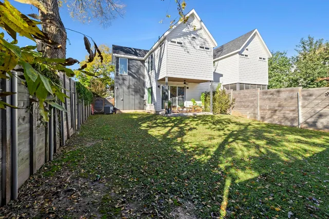 a view of a house with a yard and porch
