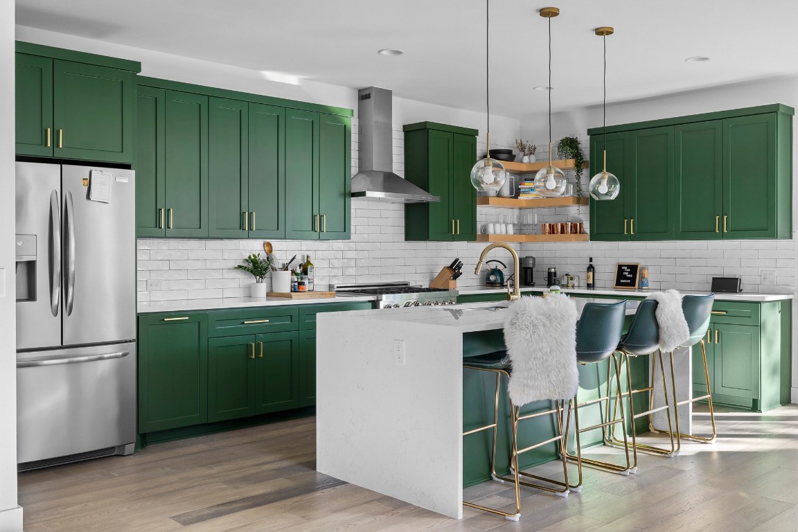 404 Powell Circle, Unit B Austin, TX 78704 - Photo 9 of 33 a kitchen with stainless steel appliances granite countertop a refrigerator a sink and a wooden floors