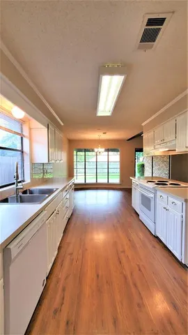an empty room with a fan and a window