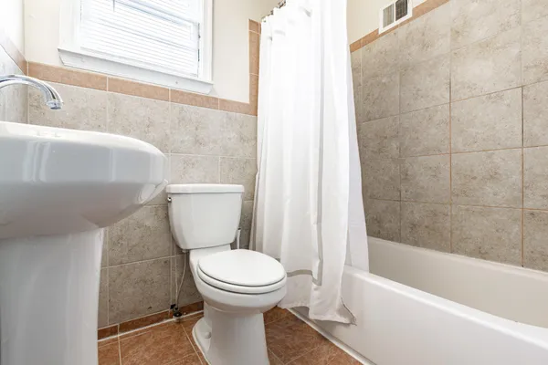 a bathroom with a toilet and a bathtub