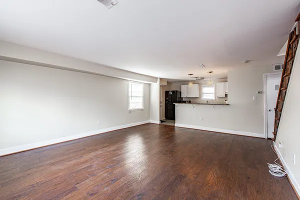 a view of a kitchen with a wooden floor and electronic appliances