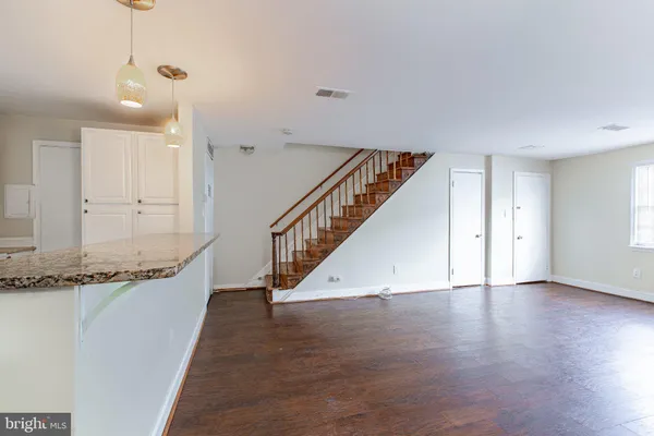 a view of an entryway with wooden floor