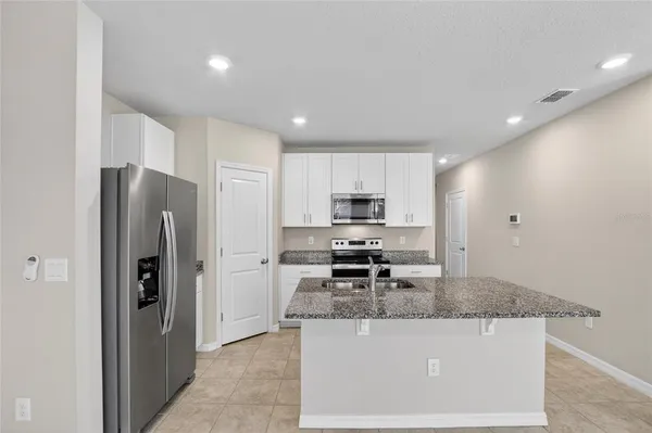 a living room with furniture kitchen and a table