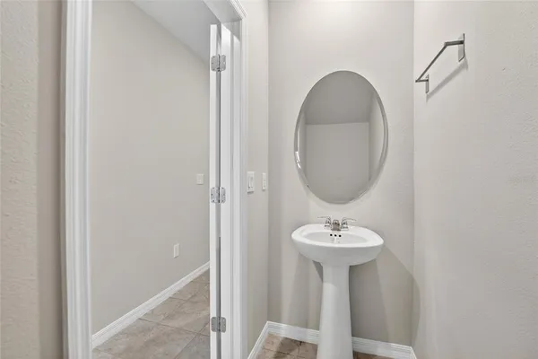 an empty room with a window and ceiling fan