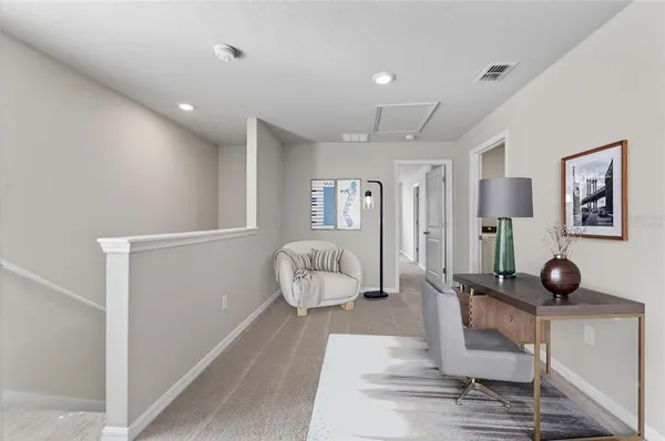 a bedroom with a bed a chandelier and couches