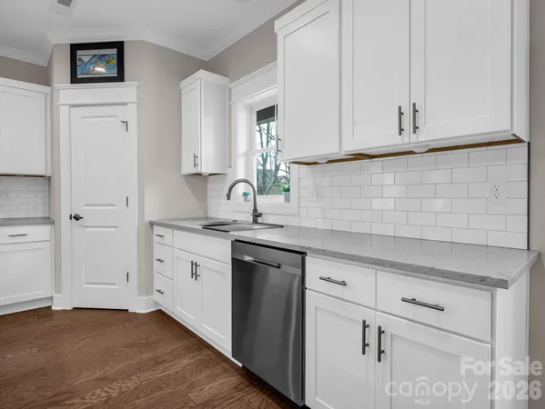 a kitchen with white cabinets and a sink