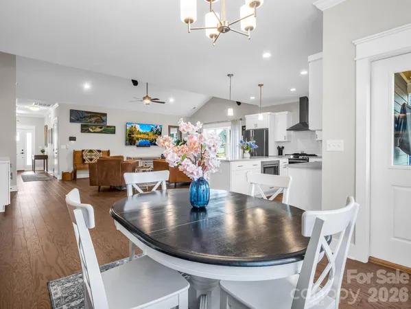 a large kitchen with a table and chairs