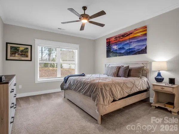 a spacious bedroom with a bed and a window