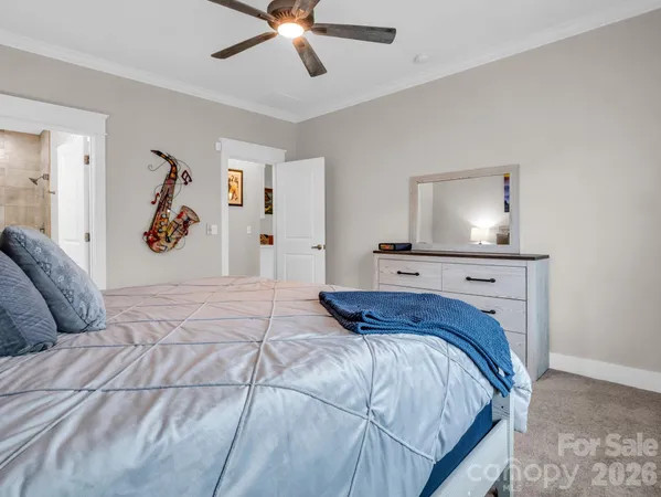 a bedroom with a large bed and a chandelier