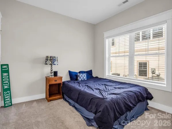 a bedroom with bed and window