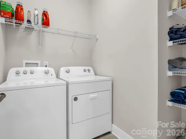 a bathroom with a granite countertop sink mirror vanity and toilet