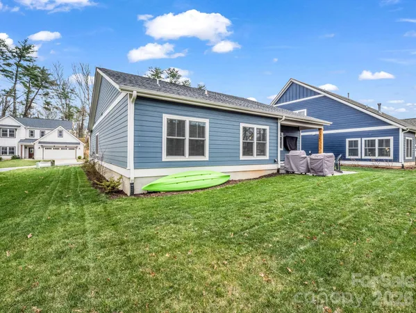 a backyard of a house with table and chairs