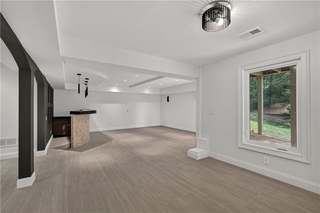 4610 West Morton Road Alpharetta, GA 30022 - Photo 37 of 53 an empty room with wooden floor and windows