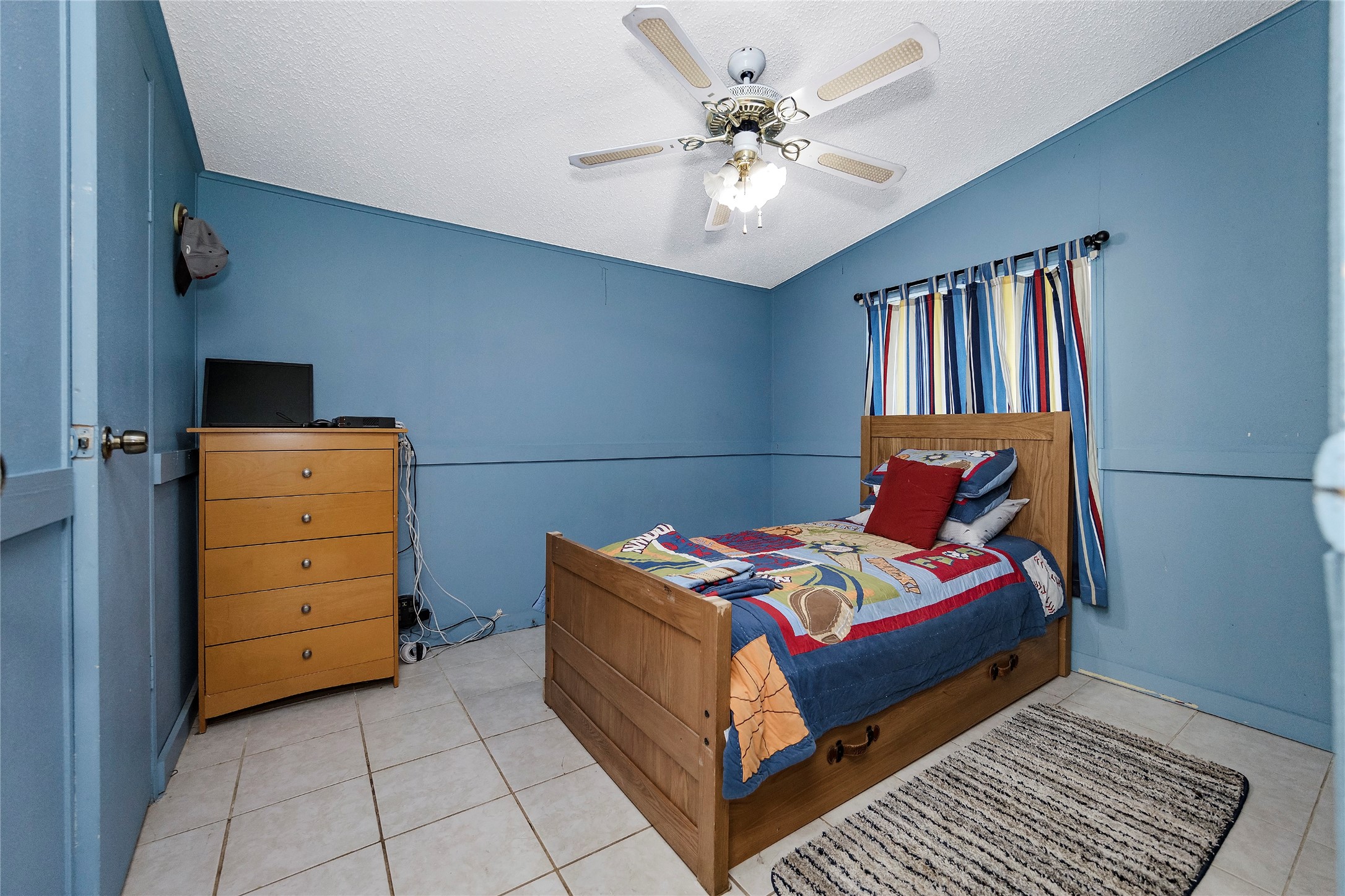 Tbd Wiggins Road Conroe, TX 77302 - Photo 12 of 16 a bedroom with a bed and a chandelier