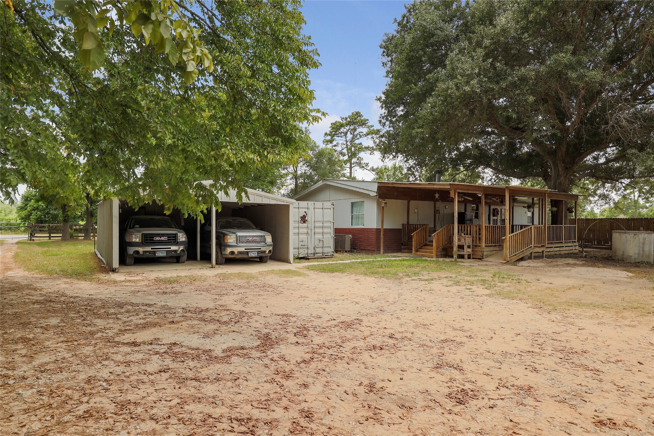 Tbd Wiggins Road Conroe, TX 77302 - Photo 15 of 16 a front view of a house with a garden and trees