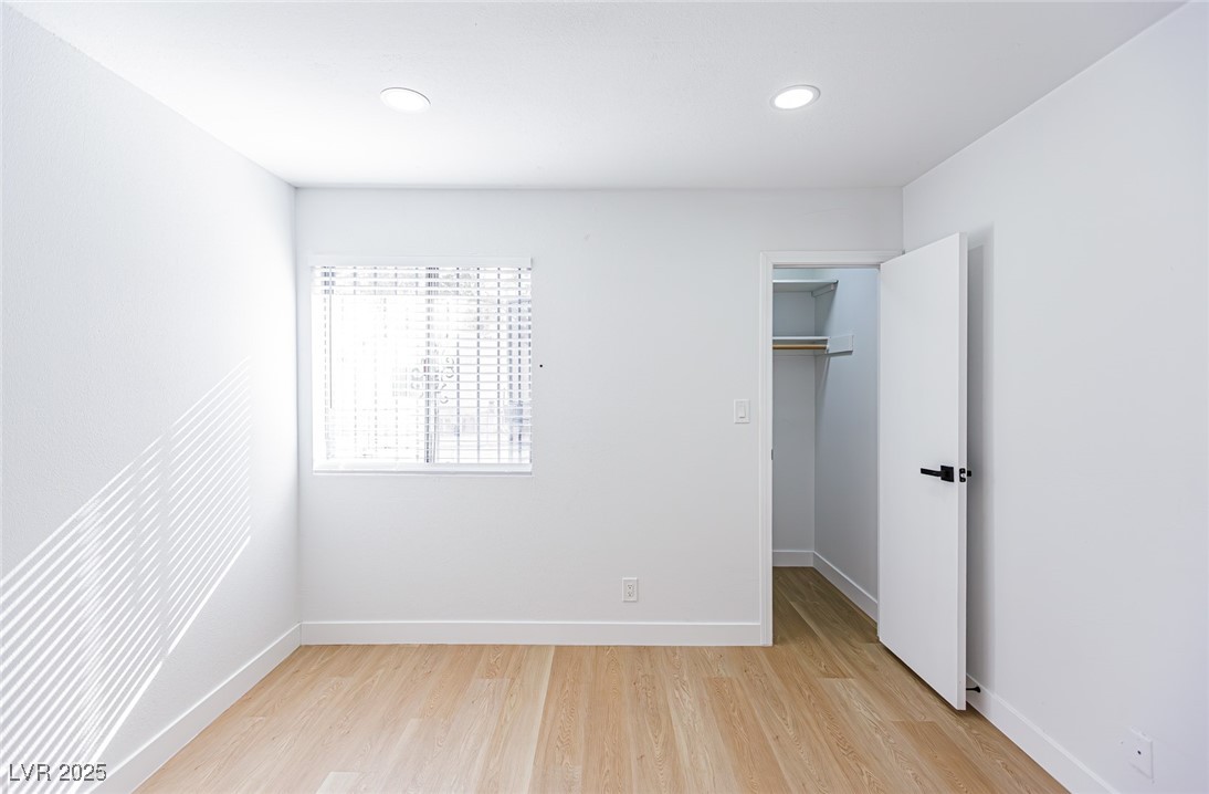 661 Riata Way Las Vegas, NV 89110 - Photo 16 of 30 Unfurnished bedroom with a walk in closet, light wood-style flooring, and recessed lighting