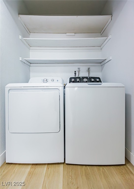 661 Riata Way Las Vegas, NV 89110 - Photo 21 of 30 Washroom with light wood-style flooring and washing machine and clothes dryer
