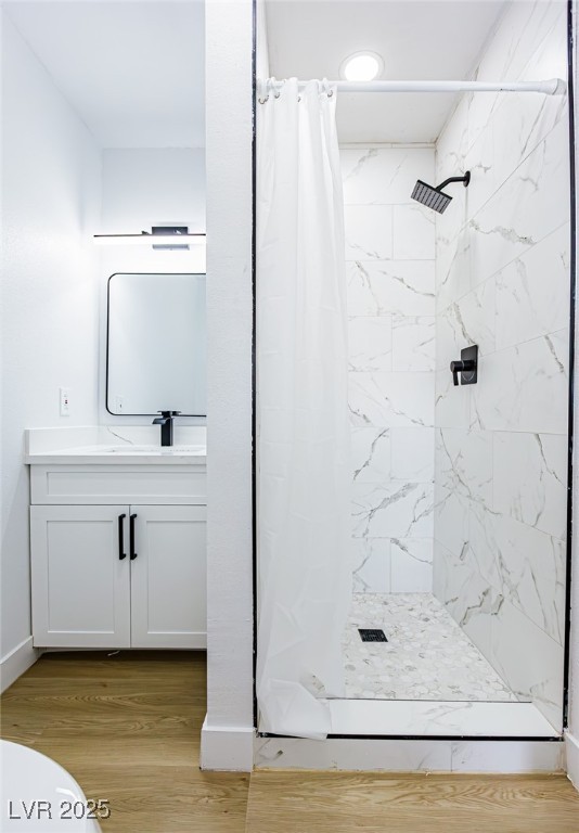 661 Riata Way Las Vegas, NV 89110 - Photo 24 of 30 Full bathroom featuring a stall shower, vanity, and light wood-style flooring