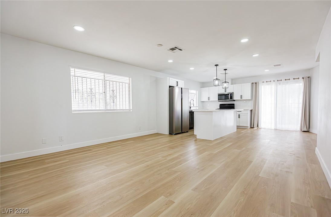 661 Riata Way Las Vegas, NV 89110 - Photo 6 of 30 Unfurnished living room featuring recessed lighting and light wood-type flooring