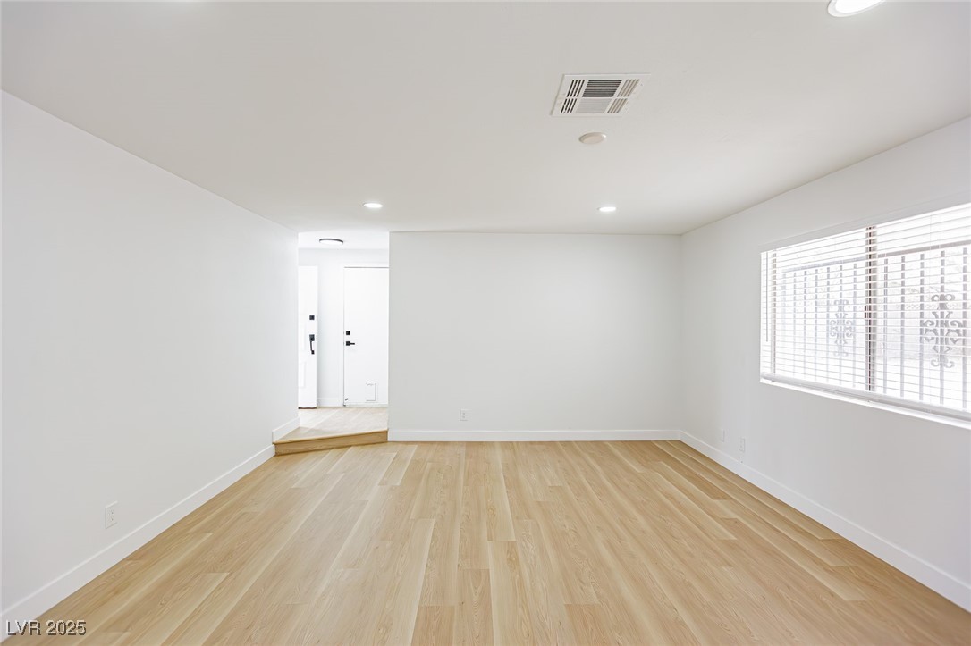 661 Riata Way Las Vegas, NV 89110 - Photo 9 of 30 Spare room with light wood-type flooring and recessed lighting