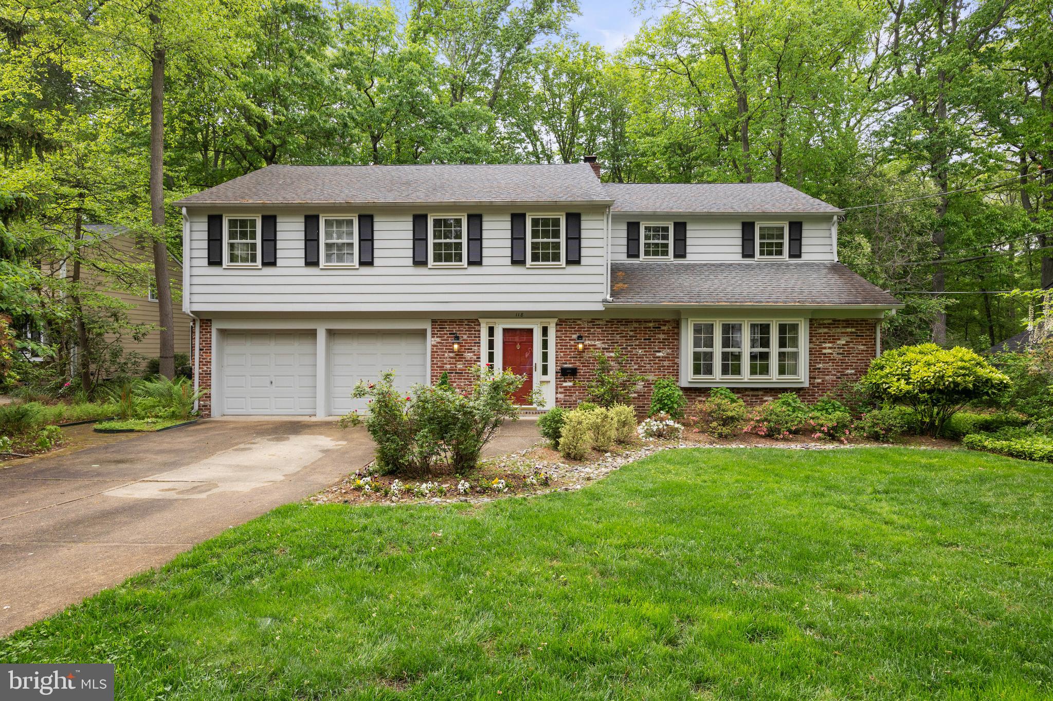 a front view of a house with a yard and porch