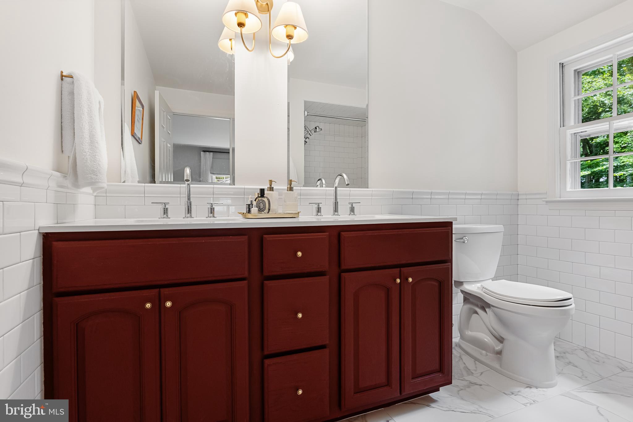 118 Barcroft Drive Cherry Hill, NJ 08034 - Photo 50 of 75 a bathroom with a double vanity sink a toilet and a mirror