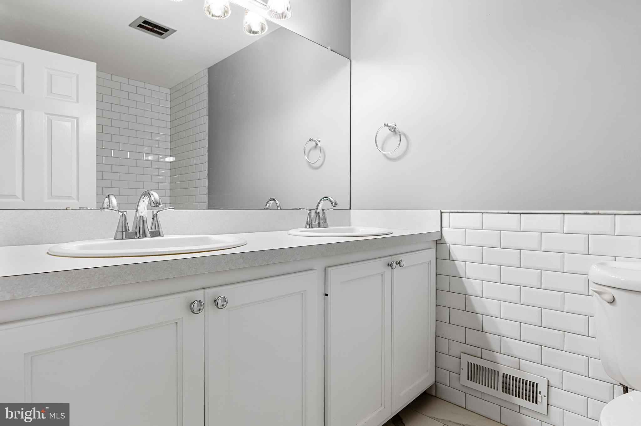 118 Barcroft Drive Cherry Hill, NJ 08034 - Photo 60 of 75 a bathroom with a double vanity sink a mirror and shower