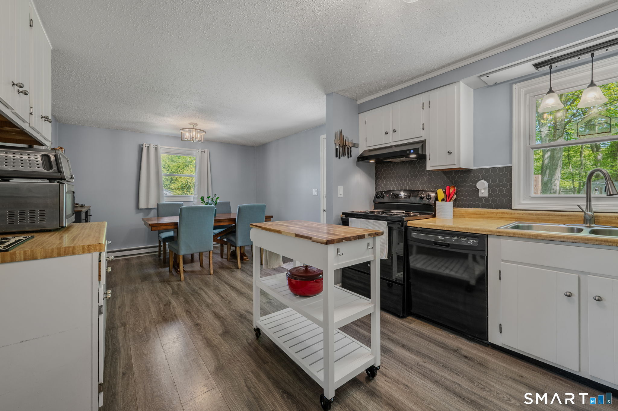 6 Amherst Court Groton, CT 06355 - Photo 11 of 40 a kitchen with stainless steel appliances a stove a sink a oven a dining table and chairs