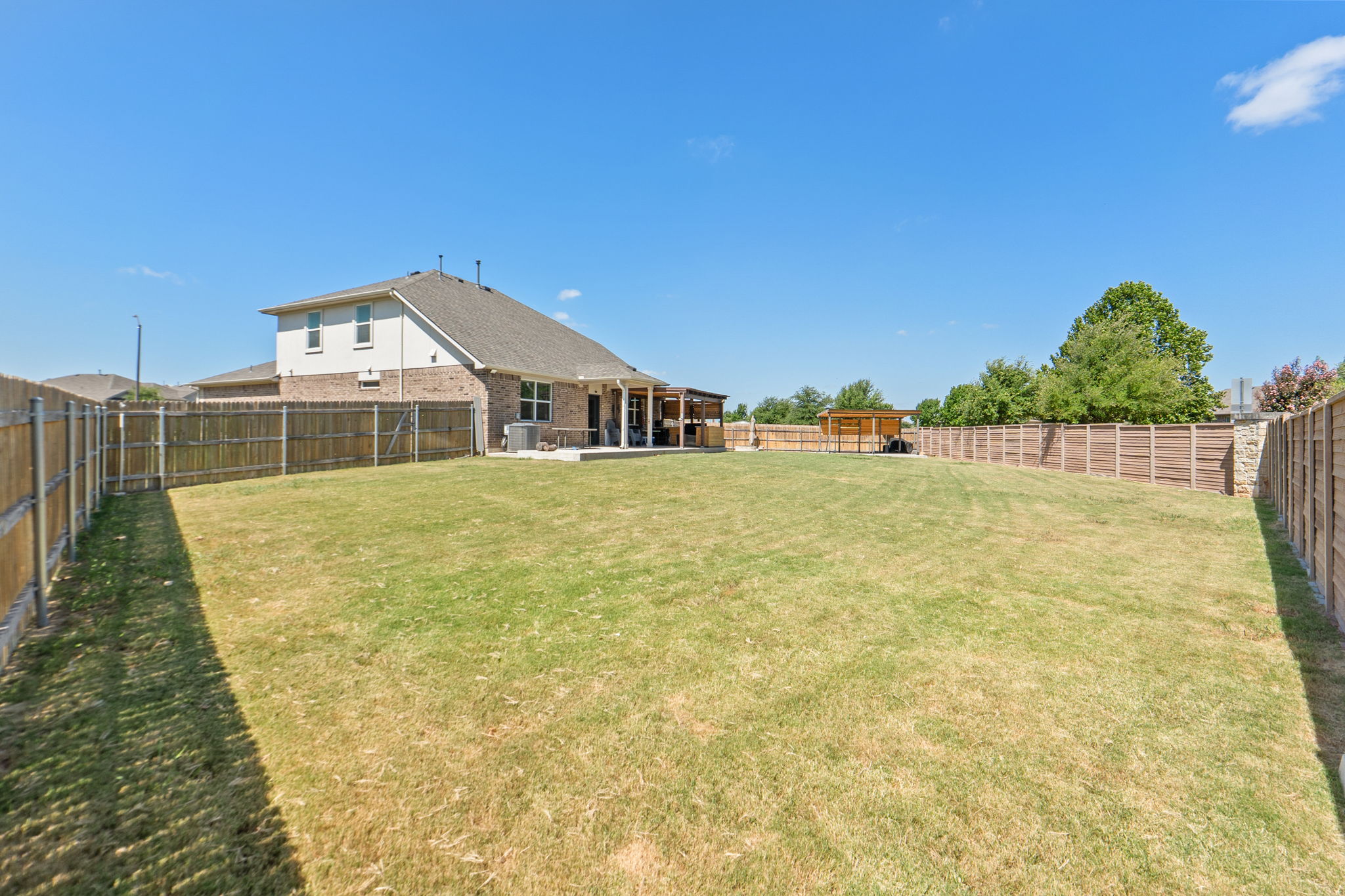 142 Brunnen Way Georgetown, TX 78626 - Photo 20 of 22 A spacious yard bordered by sturdy fencing and a private patio offers ideal outdoor living.