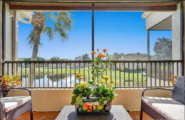 a balcony with furniture and a potted plant