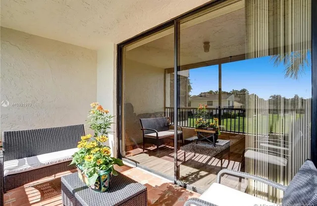 a roof deck with table and chairs potted plants