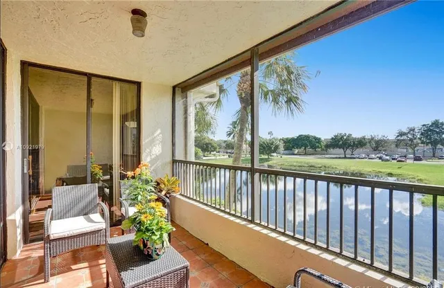 a balcony with furniture and wooden floor