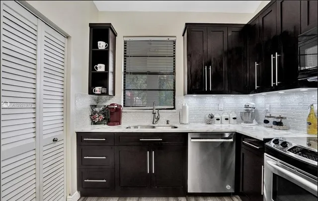 a kitchen with a sink and a stove