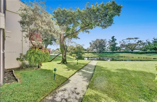 a view of yard with swimming pool and green space